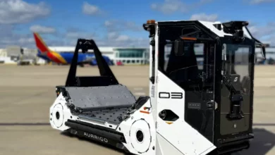Aurrigo's Auto Dolly-Tug performing a tank turn on an airport tarmac.