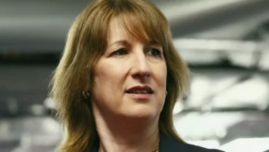 Chancellor Rachel Reeves delivers a speech at a podium in the City of London.