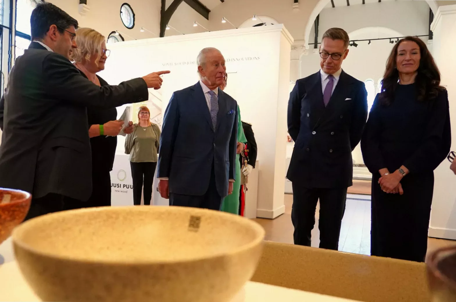 Finnish President Alexander Stubb and his wife viewing birch fibre dresses on display.