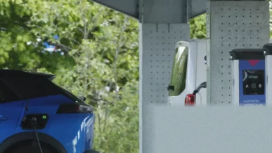 A row of electric vehicles charging on a residential street in Britain.