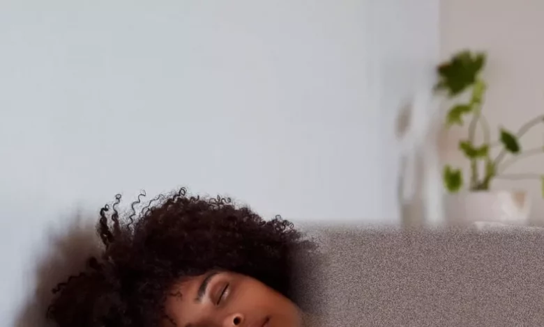 A smartwatch displaying sleep and activity data on a bedside table.