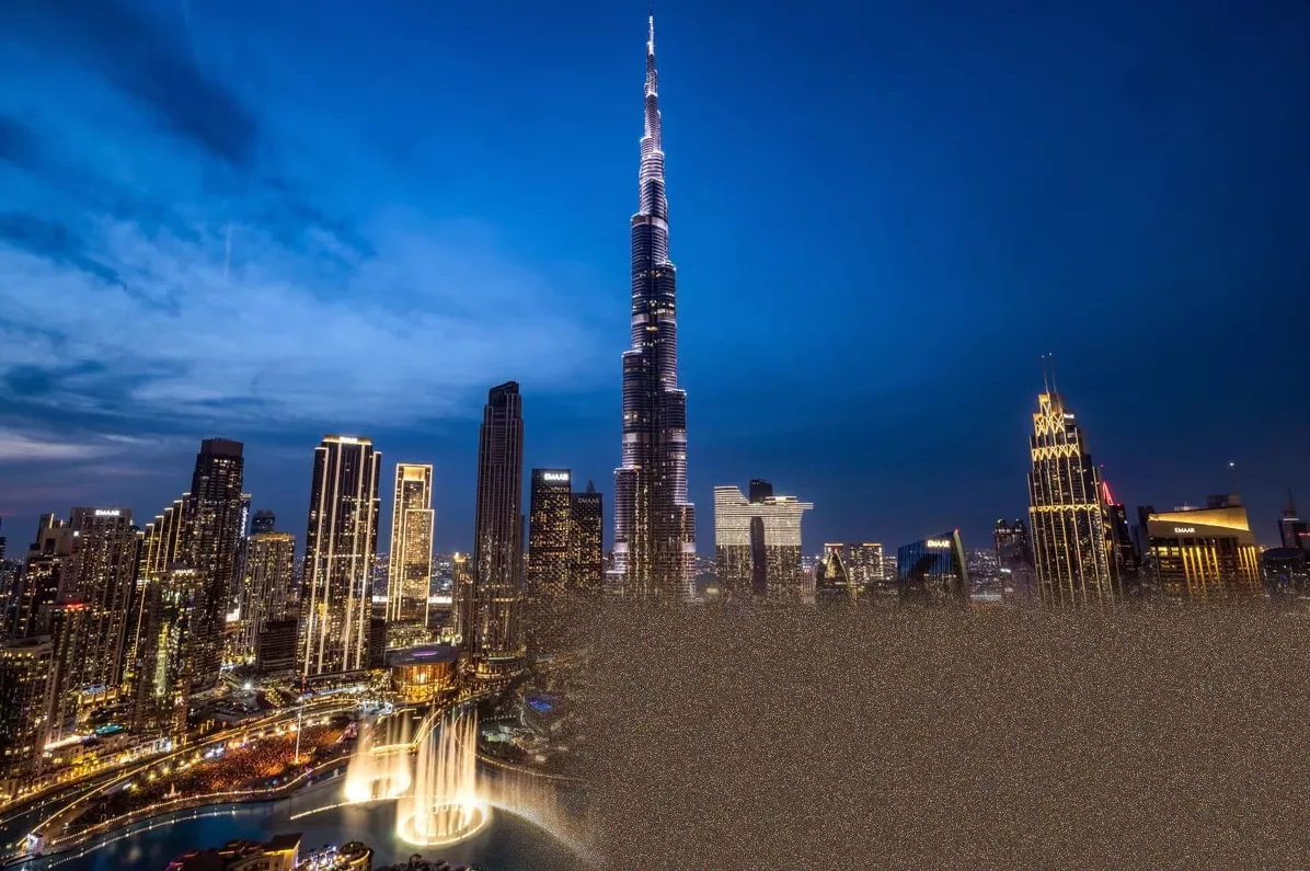 Aerial view of Dubai's skyline with commercial towers and residential areas.