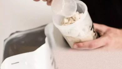 A selection of Huel nutrition shake powders and ready-to-drink bottles on a table.