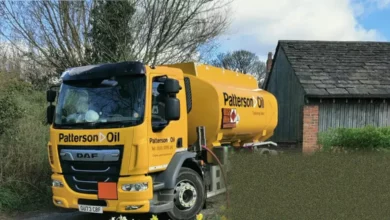 A marked heating oil tanker makes a delivery to a rural house.