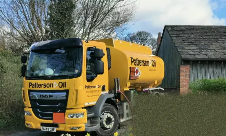 A marked heating oil tanker makes a delivery to a rural house.