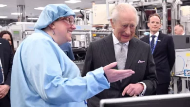 King Charles unveiling a plaque at a solar technology company's headquarters.
