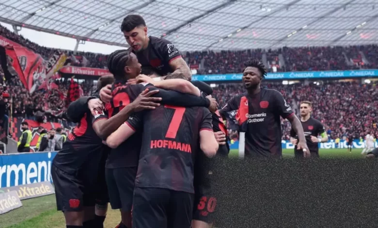 Bayer Leverkusen players celebrating a goal against Bayern Munich in a Bundesliga match.