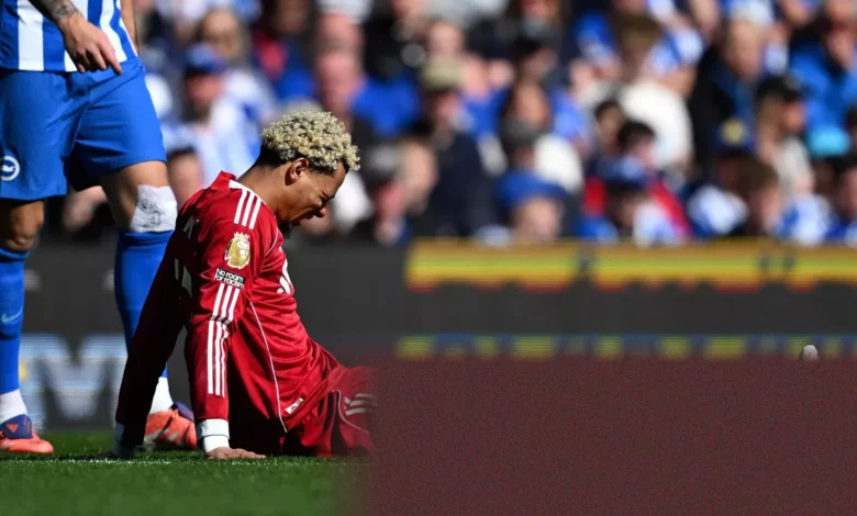 Liverpool player receiving treatment on the pitch during a match.