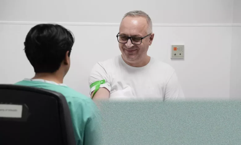 A man undergoing a medical scan at a diagnostic centre for a health trial.