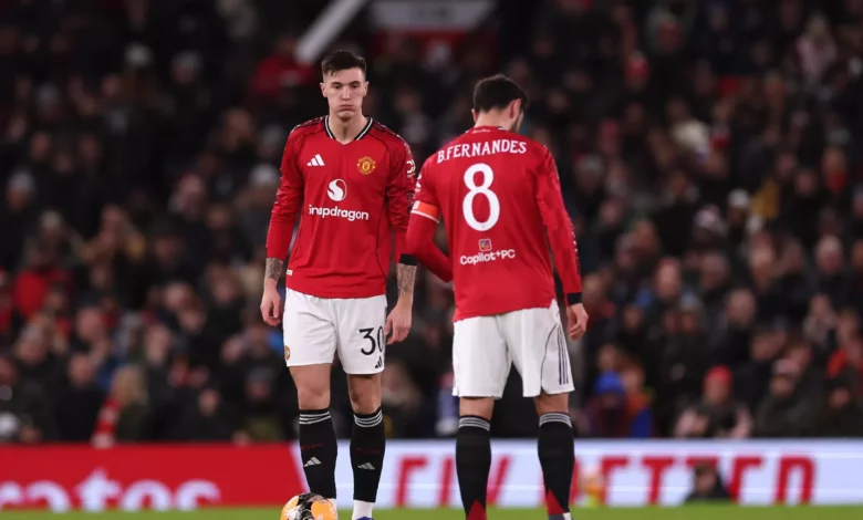 Manchester United football shirt on the Old Trafford pitch.