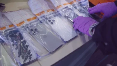 A person reporting a mobile phone theft at a UK police station counter.