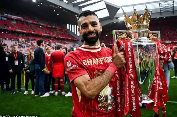 A Liverpool FC crest on a shirt or banner at Anfield stadium.
