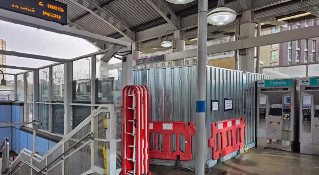 Construction workers installing new ticket gates at the station's upper concourse.