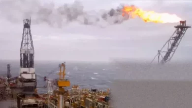 A North Sea oil rig against a stormy sky, representing energy market volatility.