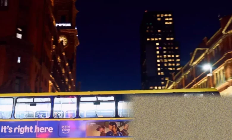 A Bee Network bus operating on a city street at night.