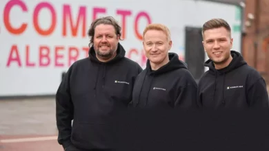 The three founders of Neurovirse collaborating in a modern office space.
