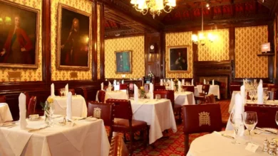 The historic Peers' Dining Room with its Pugin wallpaper and formal tables.