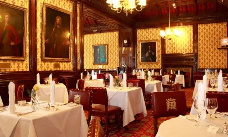 The historic Peers' Dining Room with its Pugin wallpaper and formal tables.
