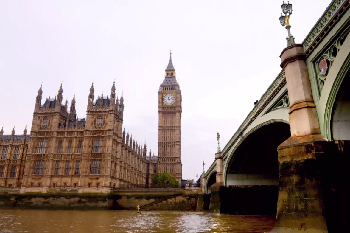 Conceptual image showing cryptocurrency symbols overlaying a UK political poster.