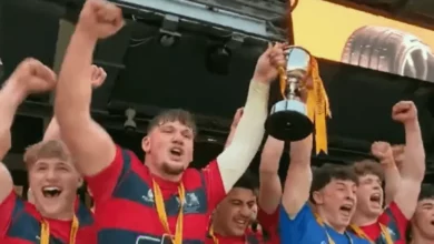 Northampton School for Boys players celebrating with the U18 Schools Cup trophy.
