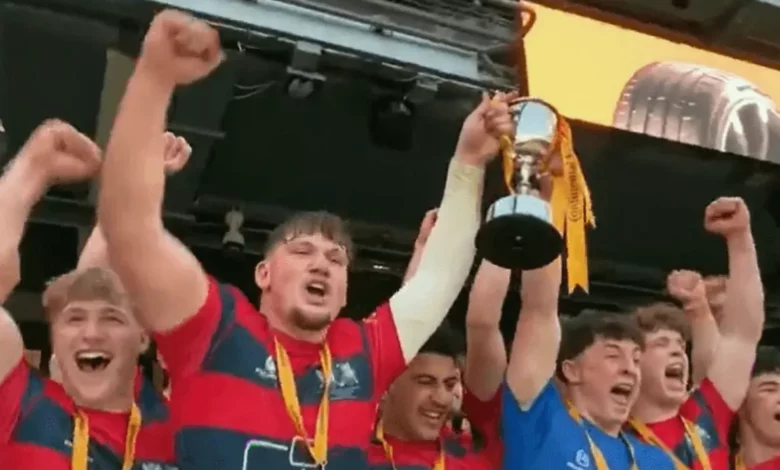 Northampton School for Boys players celebrating with the U18 Schools Cup trophy.
