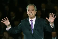 Nigel Farage and Robert Jenrick at a podium announcing the energy bill prize draw.