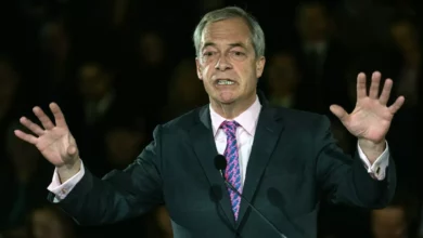 Nigel Farage and Robert Jenrick at a podium announcing the energy bill prize draw.