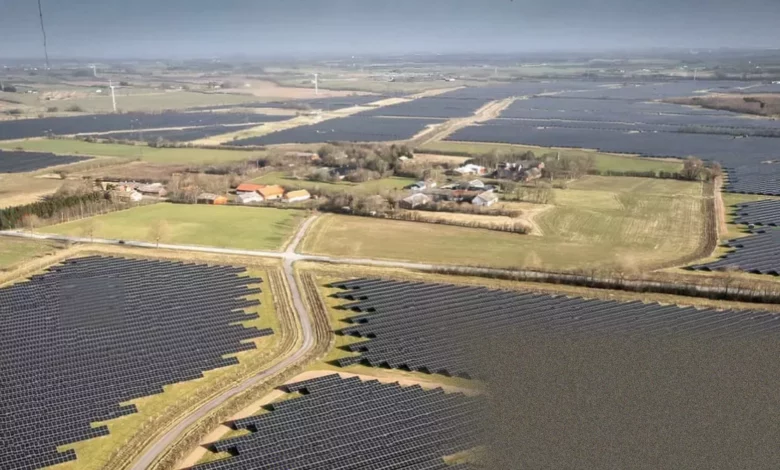 Aerial view of a large solar panel array on Danish farmland.