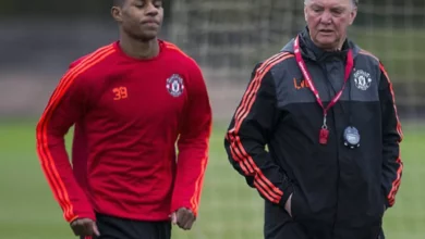 A Manchester United academy graduate holding a first-team shirt.