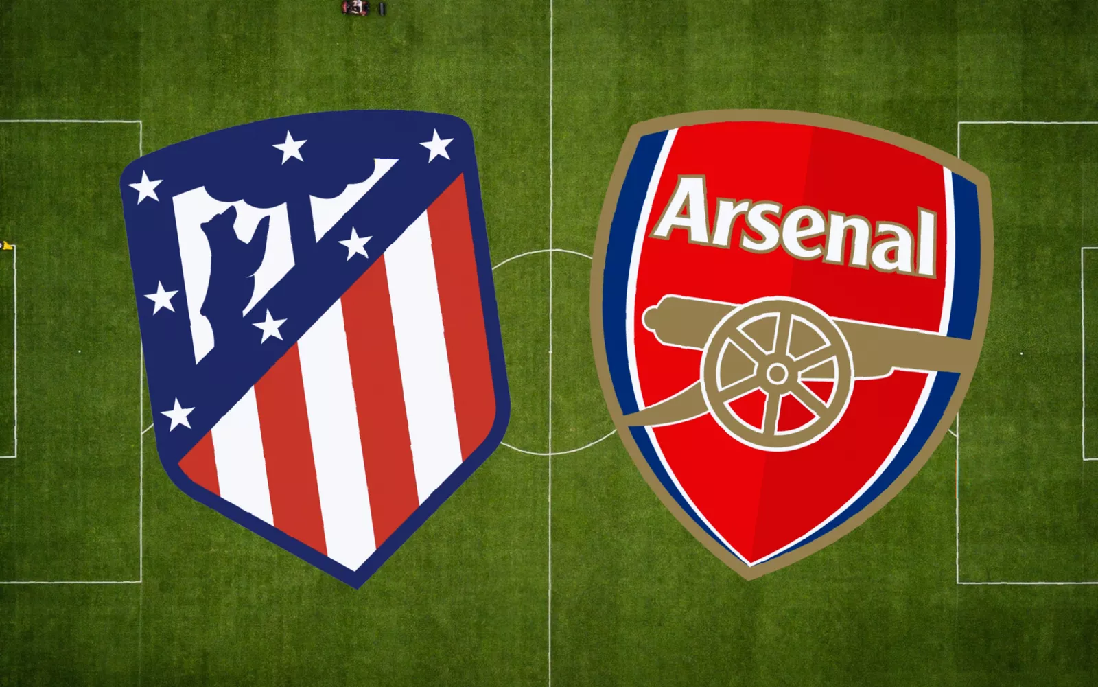 Atletico Madrid players training on a damp and patchy grass surface