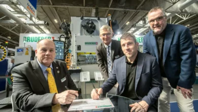 A high-speed precision press operating in a UK manufacturing facility.