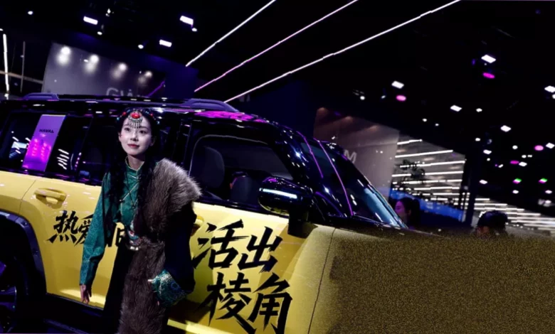 Crowded exhibition hall at the Beijing Auto Fair displaying hundreds of vehicles