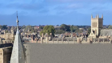 Aerial view of historic university buildings and modern construction sites.