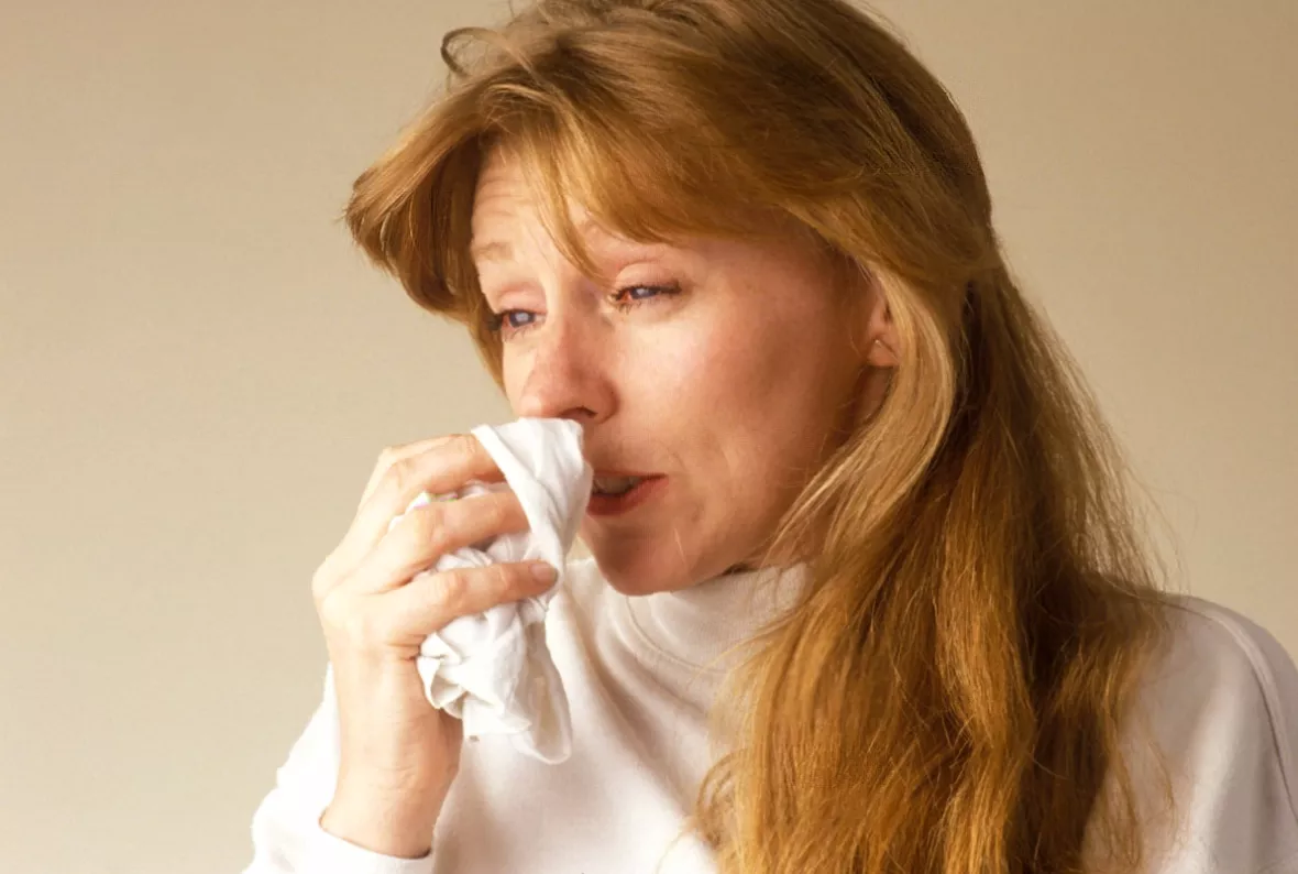 Close-up of a pharmacy shelf lined with over-the-counter nasal sprays