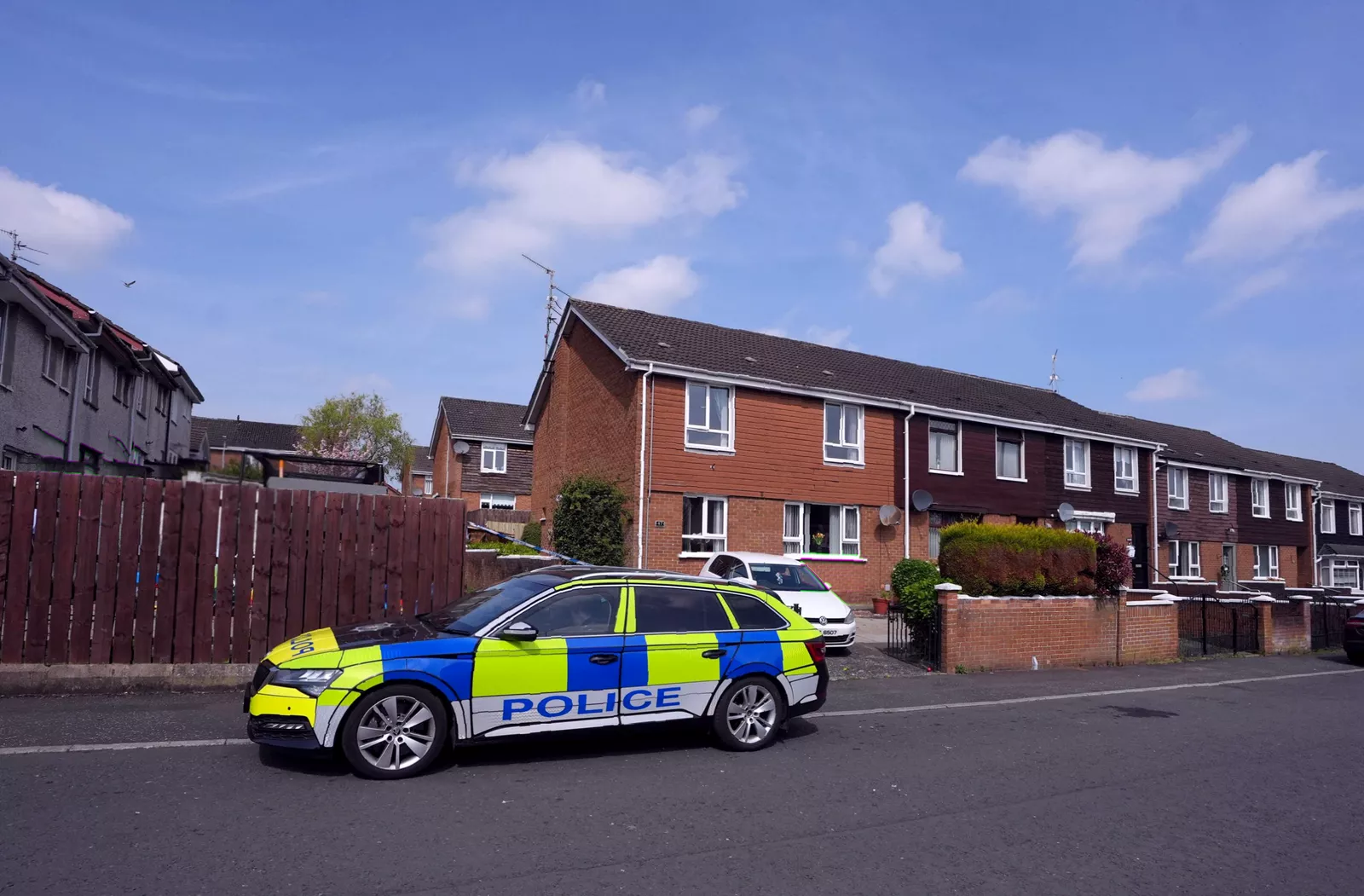 Police cordon and emergency vehicles at Dunmurry station after the attack