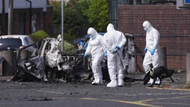 Police station exterior after car bomb explosion in west Belfast residential area