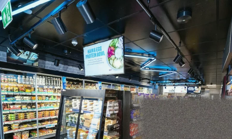 A Co-op supermarket aisle showing alcohol and laundry products, commonly targeted by shoplifters
