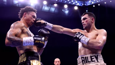 Boxers in a ring at Tottenham Hotspur Stadium during a major fight night.