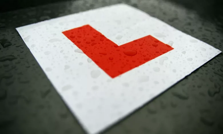 A driving school car parked on a UK street for a learner lesson.