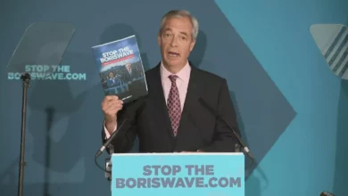 A political press conference podium with microphones in Westminster.