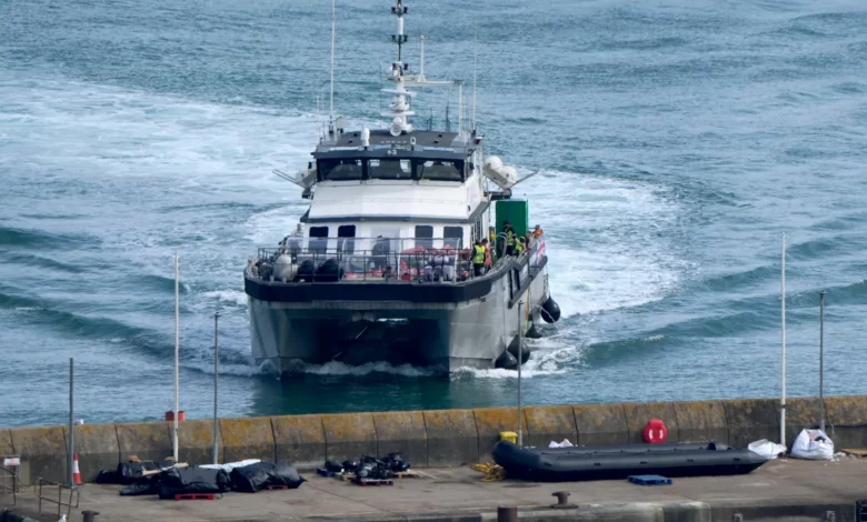 A group of migrants being escorted into the Border Security Command compound in Dover