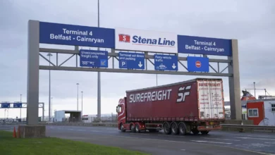 A line of lorries parked at a UK freight depot or industrial estate.