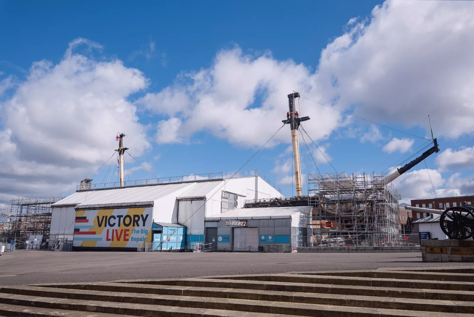 Visitors watching restoration work on HMS Victory from new viewing platforms at the dockyard