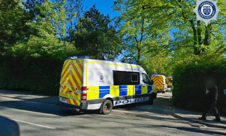 Police officers outside the Webb House headquarters of a religious group in Crewe