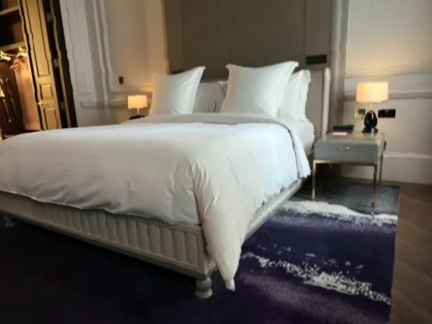 Elegant Heritage Suite interior with high ceilings and marble bathroom