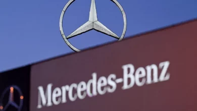 A Mercedes-Benz showroom in the UK, with new cars on display and a sign advertising finance options.