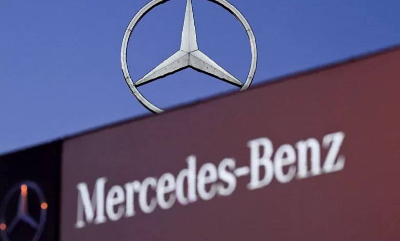 A Mercedes-Benz showroom in the UK, with new cars on display and a sign advertising finance options.