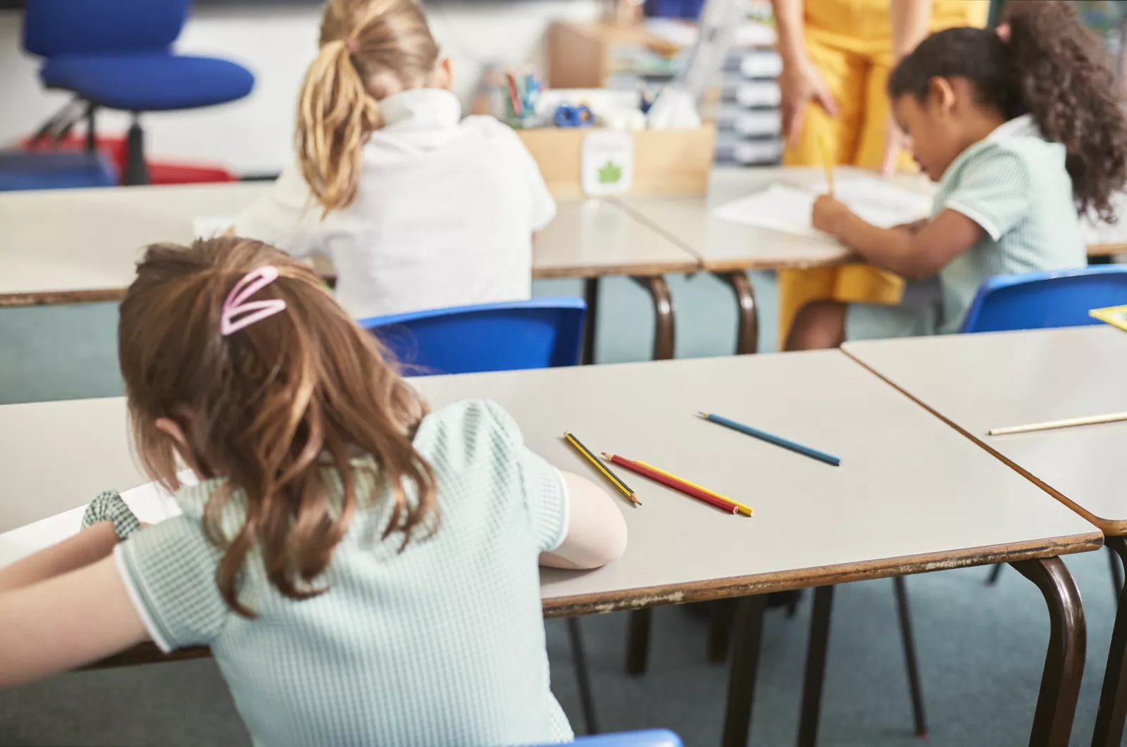 A classroom setting where pupils are wearing casual sportswear instead of formal attire.