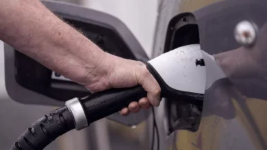 Electric cars plugged into public charging points on a UK high street