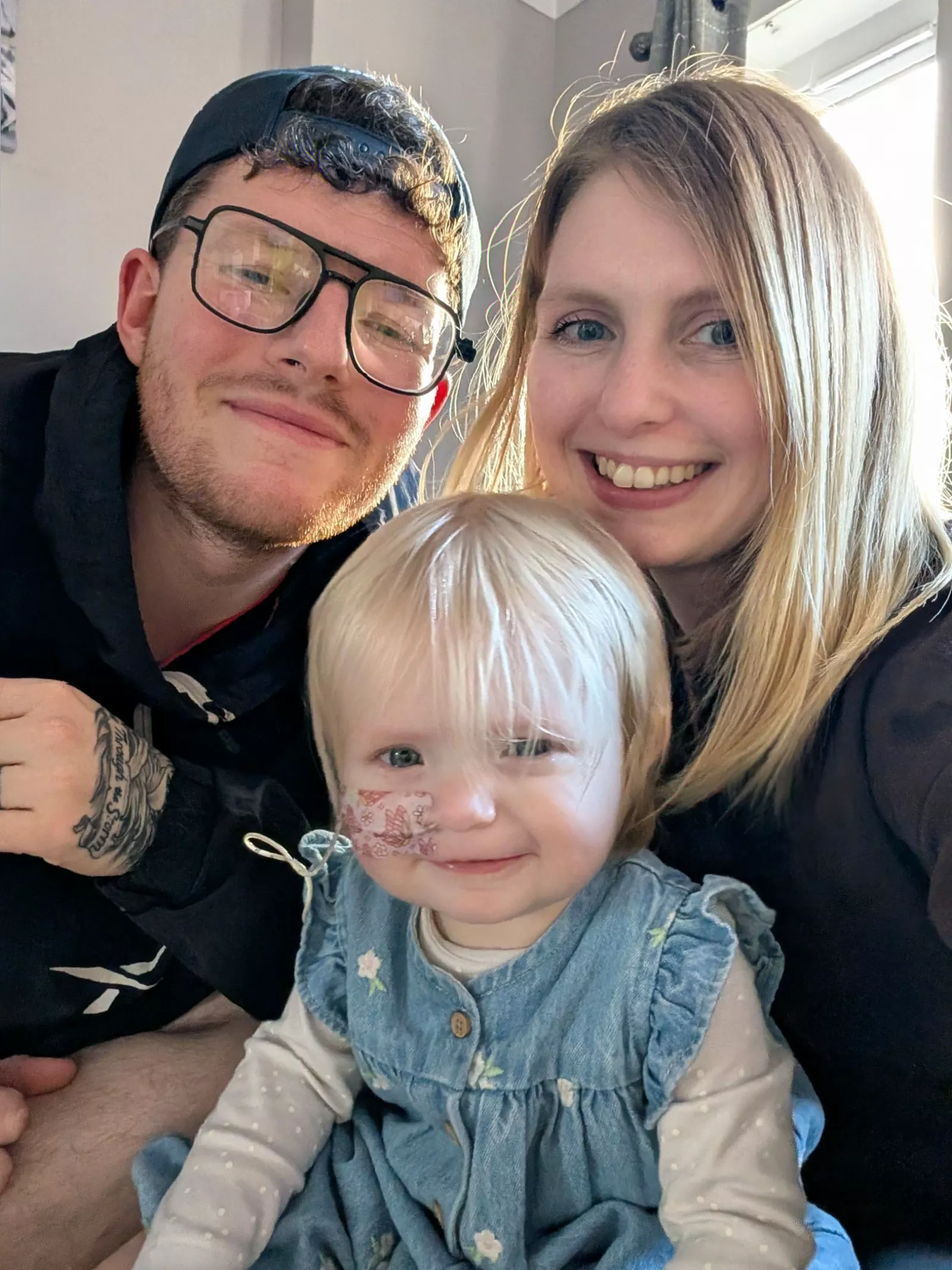 A family supporting a young child with a feeding tube at home.